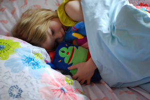 girl asleep with potato monster tooth pillow